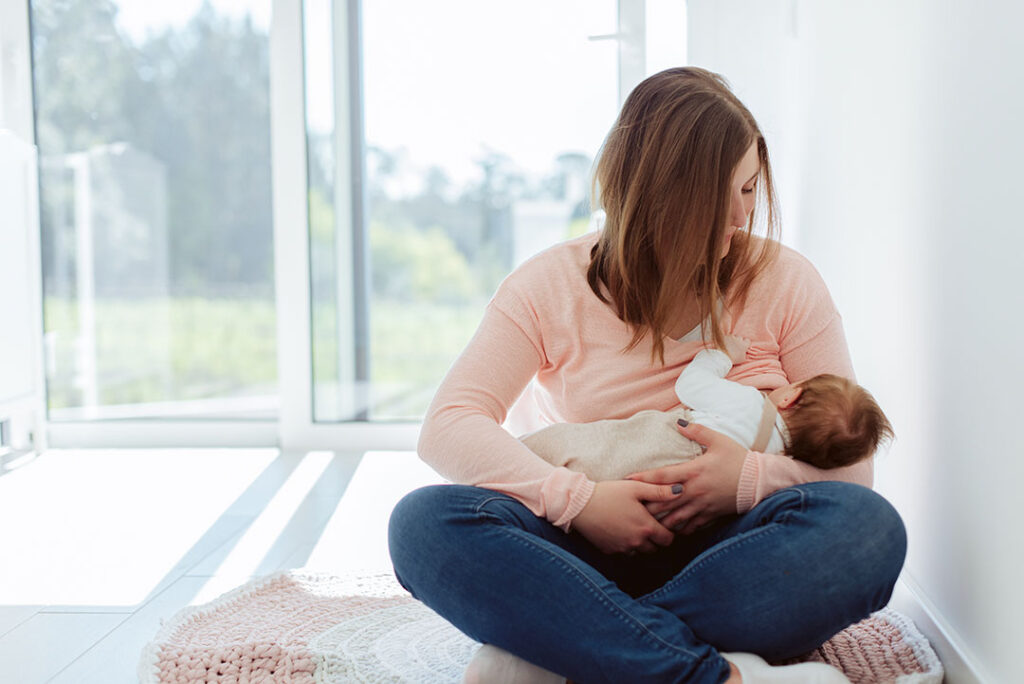 Young Mother breastfeeding newborn baby